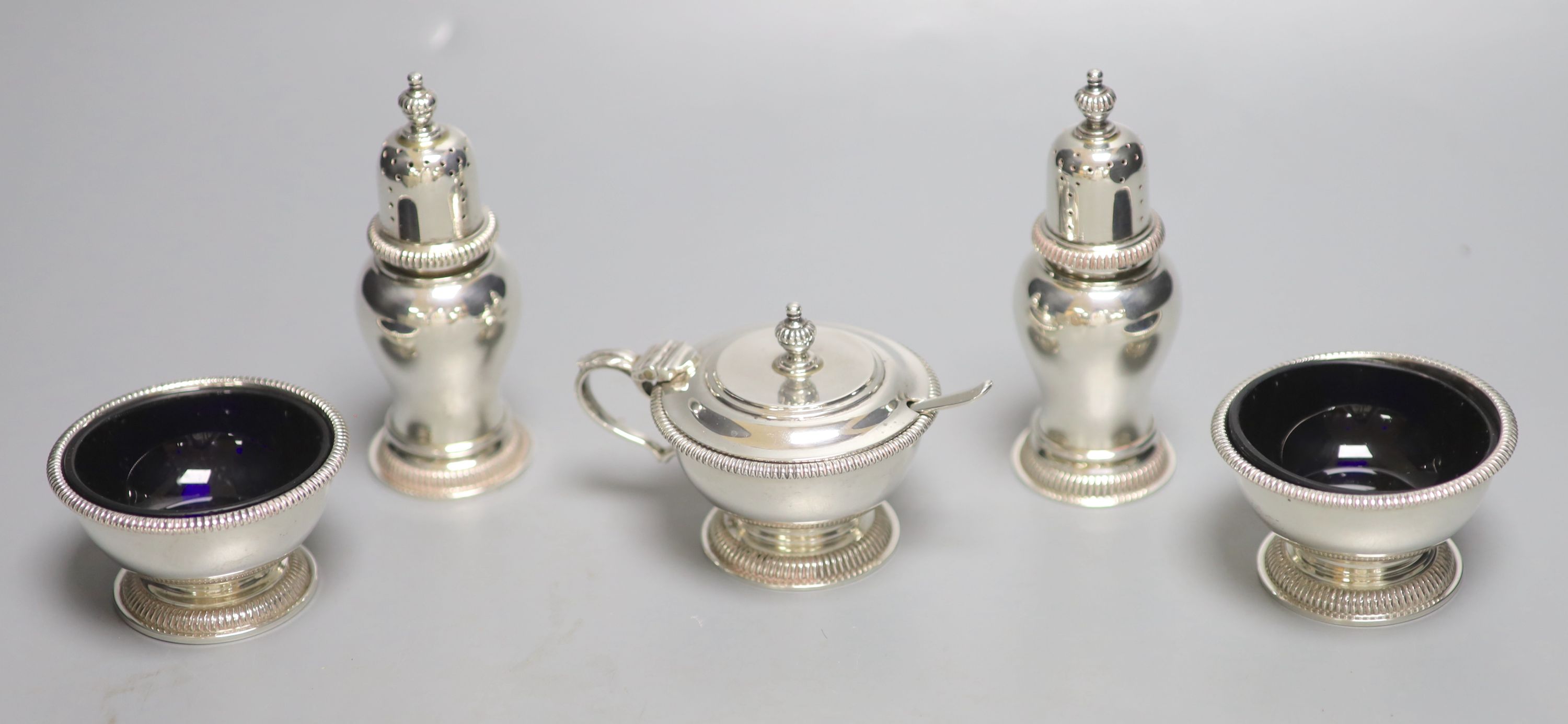 A modern silver five piece condiment set including one spoon, by William Comyns & Sons Ltd, London, 1960 & 1967,